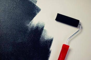 Catalyst Painting roller applying a fresh coat on a Kansas City home
