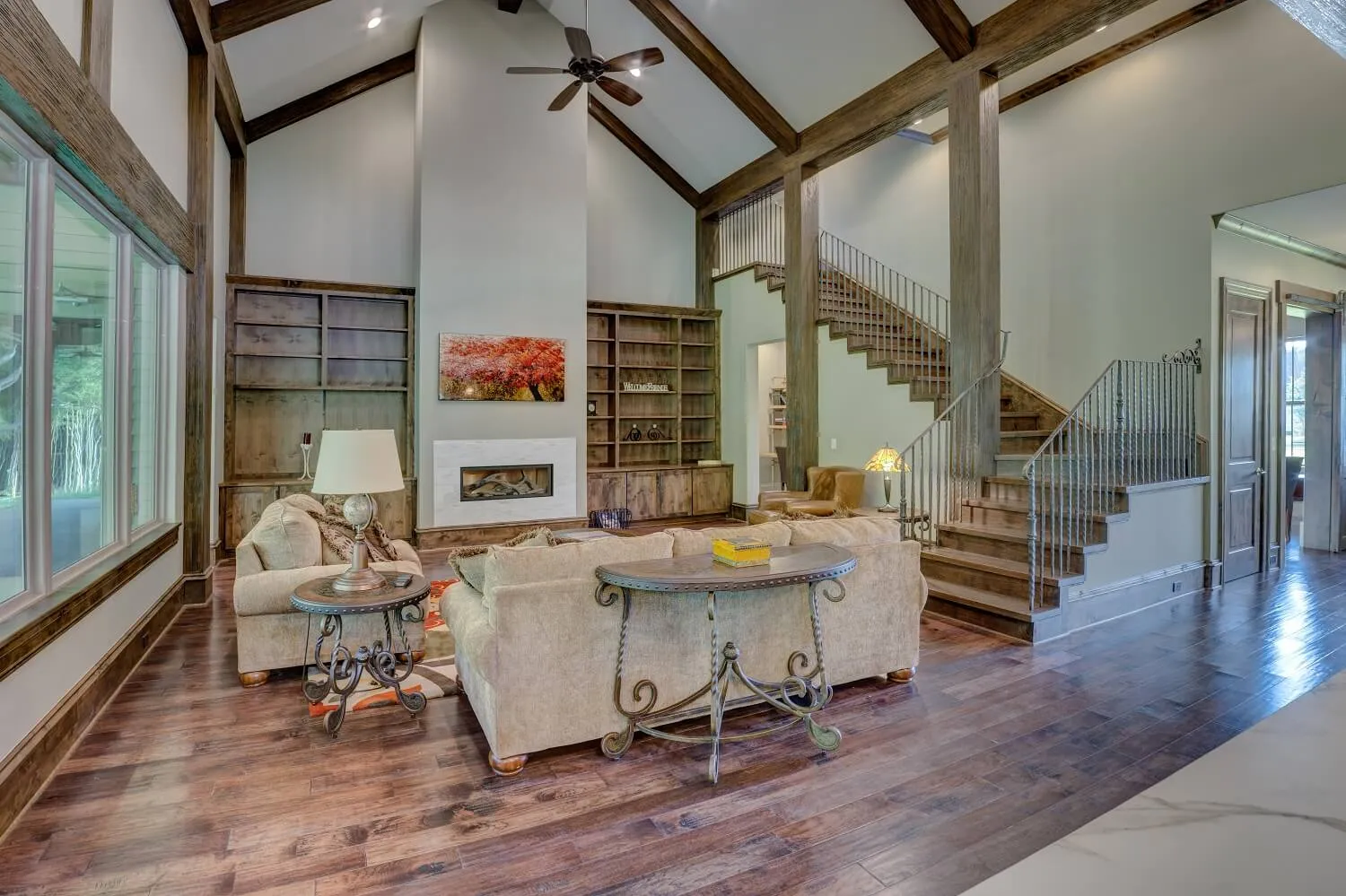 Living room with vaulted ceilings, wood beams, and freshly painted light walls
